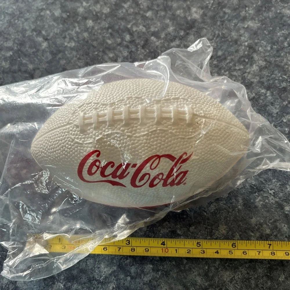 2 Collectible Coca Cola Mini Footballs. (1-leather, 1- foam) approx. 7 inches